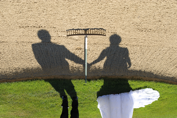 portrait of bride and groom's shadows upon raked land - wedding photo by top Portland, Oregon wedding photographer Aaron Courter